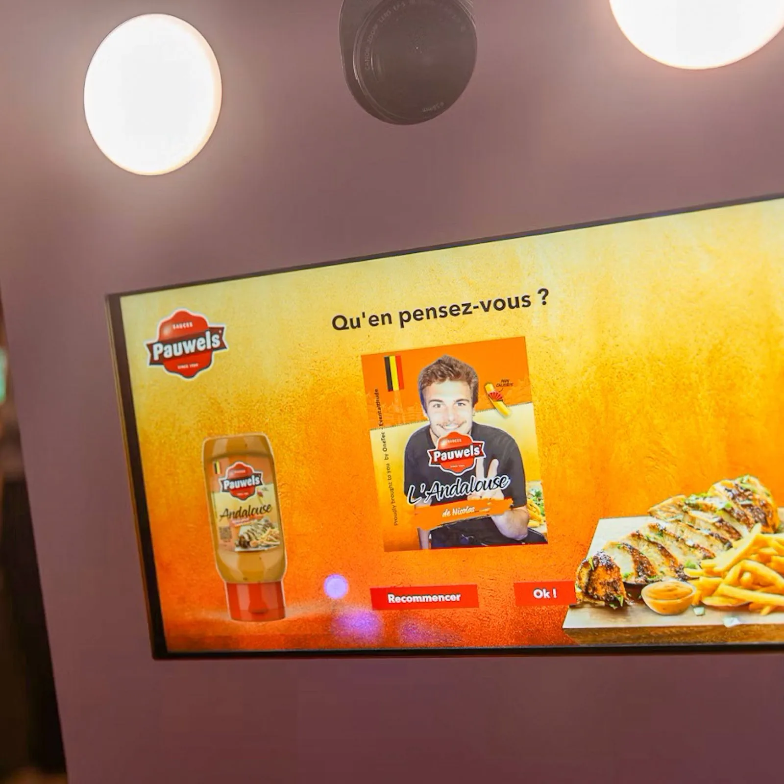The photo booth screen: the visitor checks the label with their photo and chooses to restart or confirm